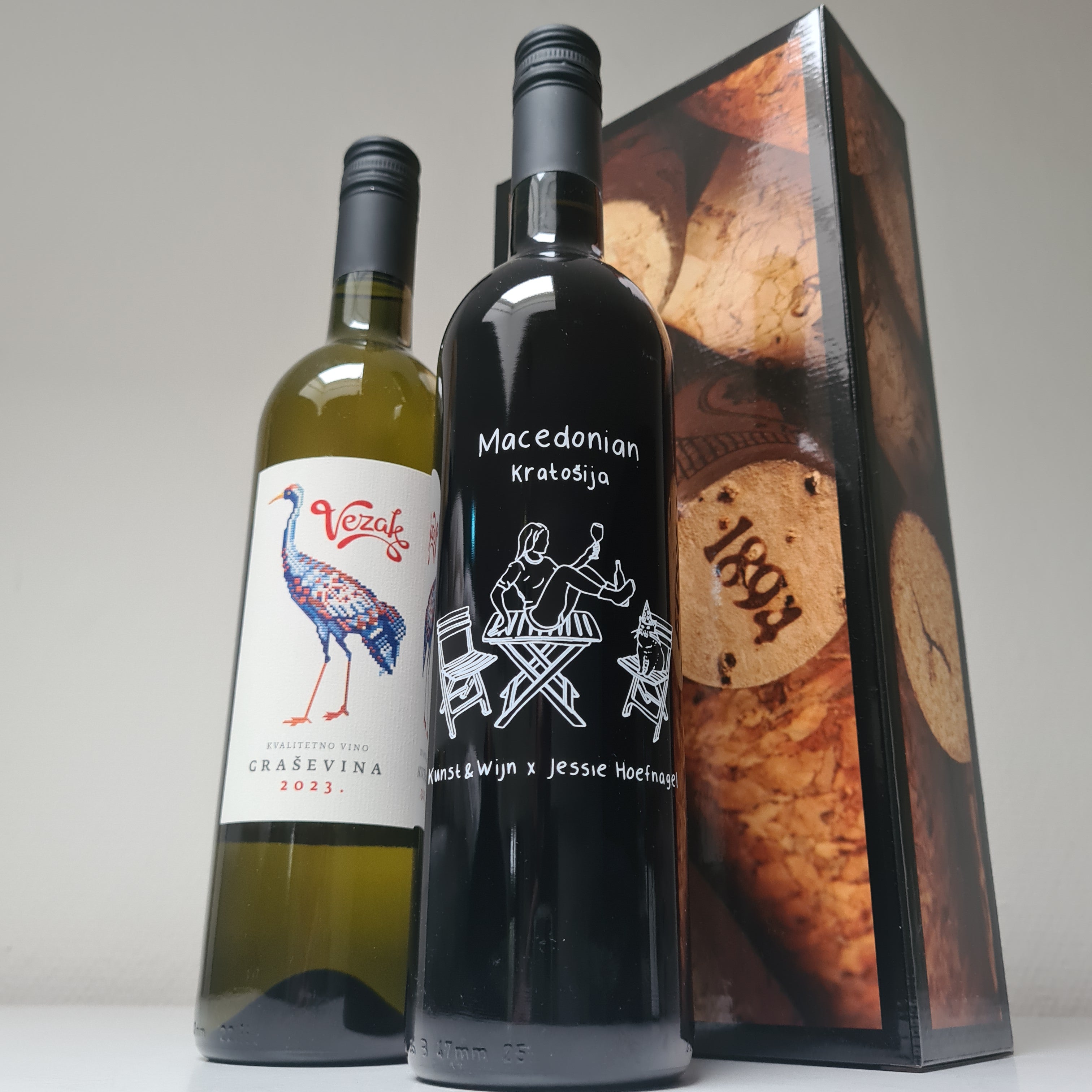 Wijndoos gemengd :

1 fles Special Edition Kratosija (rood) uit Macedonië.

Het etiket is gezeefdrukt op het glas van de fles en ontworpen door Jessie Hoefnagel in samenwerking met Kunst &amp; Wijn atelier.

1 fles Grasevina ( wit)&nbsp; uit Kroatië .

In geschenkdoos verpakt.
